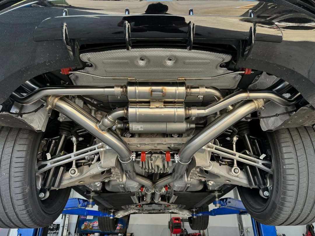 Gold Coast mechanic installing performance exhaust for car upgrades.