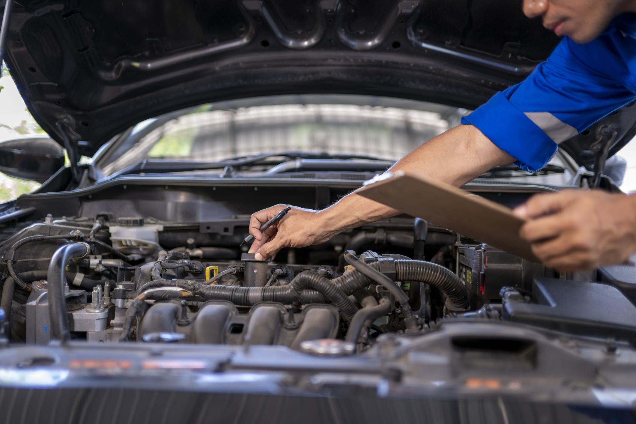 performance car maintenance inspection in workshop with sports car and mechanic