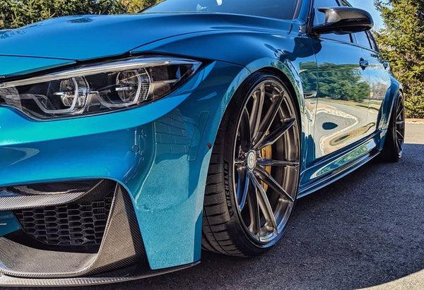 premium performance car with forged wheels and quality upgrades installed in a workshop setting