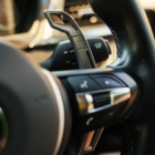 Official MMX billet gear shift paddle installed on a compatible BMW steering wheel