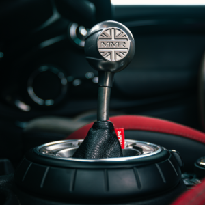 Official MMX MINI short shifter installed with titanium finish and red gaiter detail